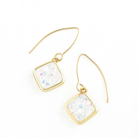Gold earrings with square white opal on a white background