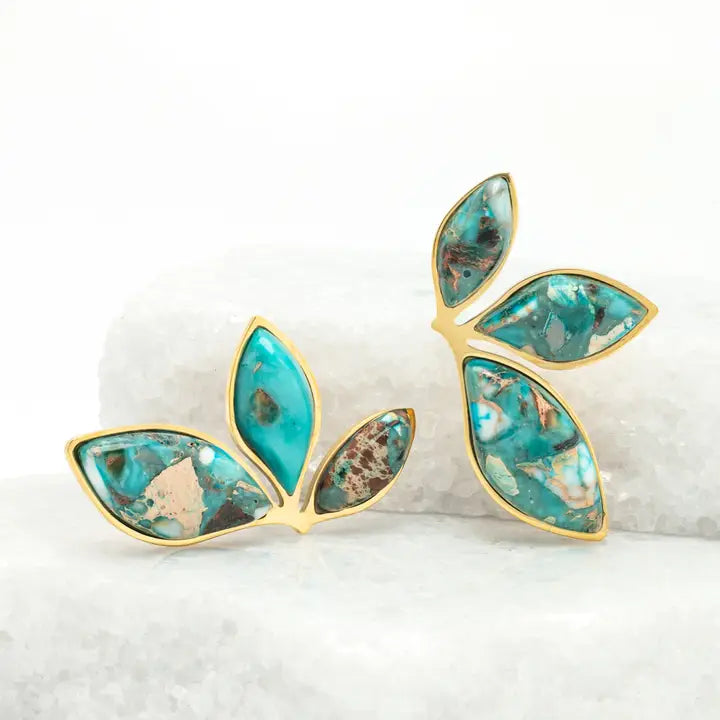 gold and emperor stone leaf earrings on a white background