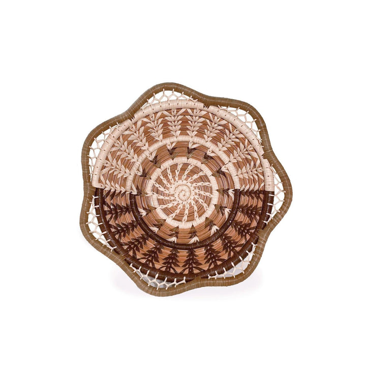 Decorative woven plate with a spiral pattern on a white background