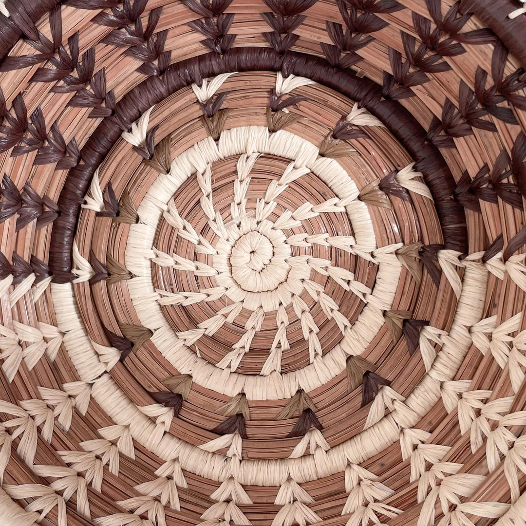 Close-up of a woven pattern with concentric circles in brown and beige.