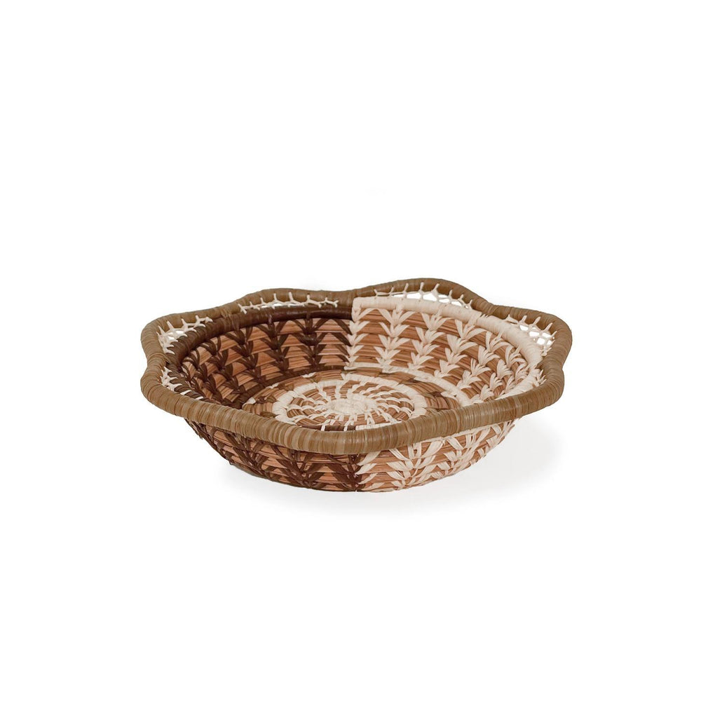 Woven basket with decorative patterns on a white background
