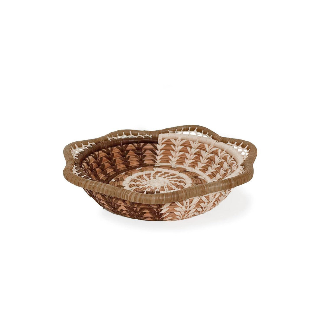 Woven basket with decorative patterns on a white background