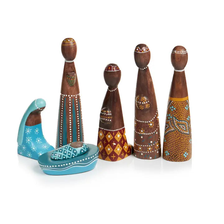 Set of five wooden figurines nativity with colorful patterns on a white background