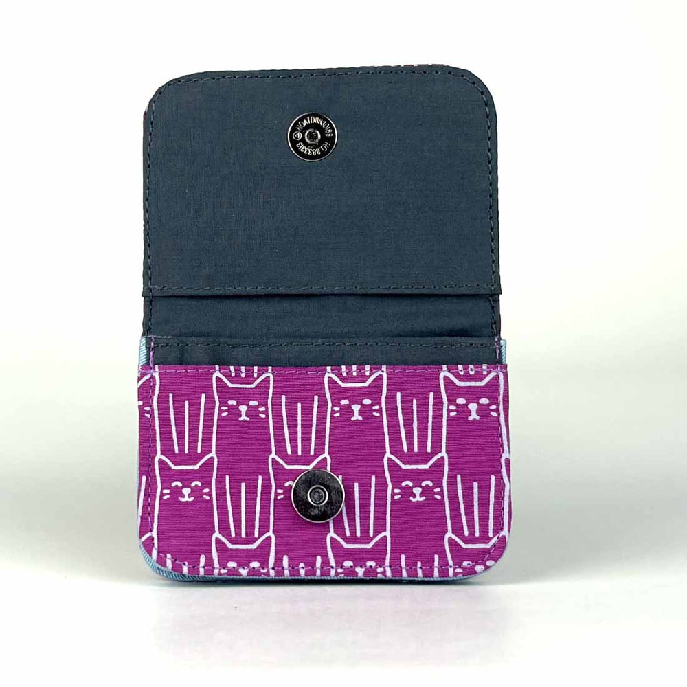 Two-tone blue and purple wallet with cat pattern on a white background