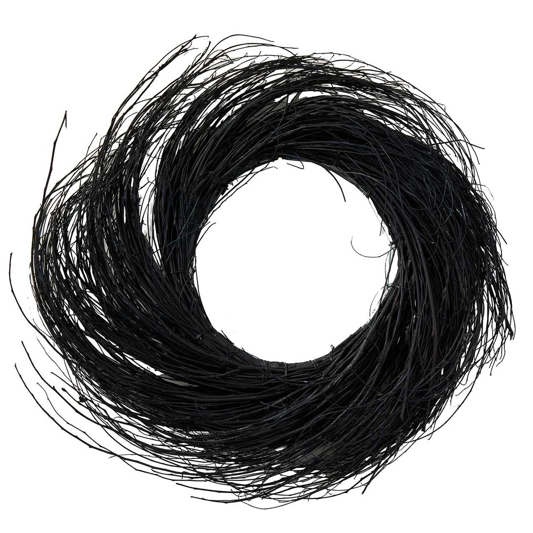 A black twig wreath on a white background