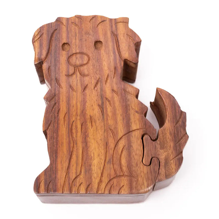 A carved wooden dog-shaped puzzle piece set on a plain white background, showcasing natural wood grain and interlocking puzzle cutlines.