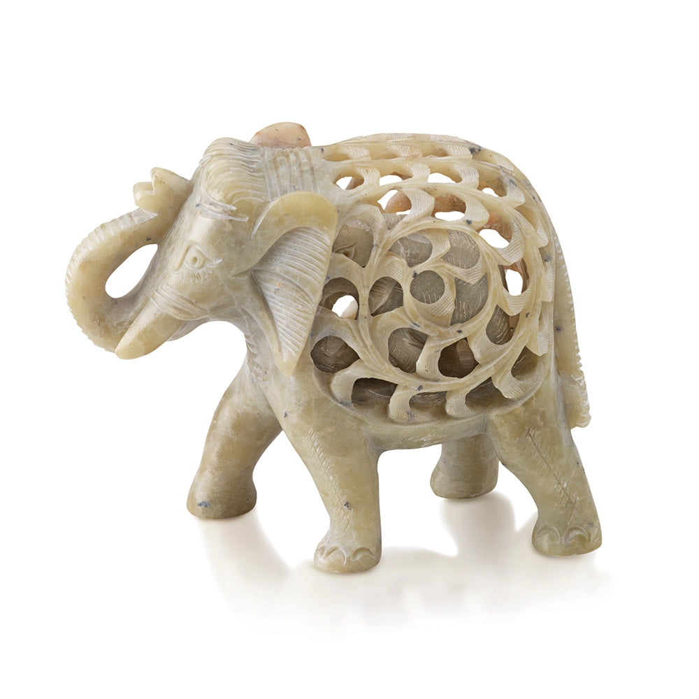 Decorative elephant figurine with intricate carvings on a white background