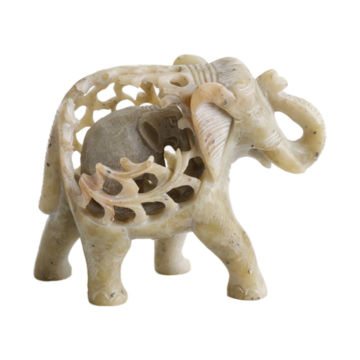 Decorative stone elephant figurine with intricate carvings on a white background