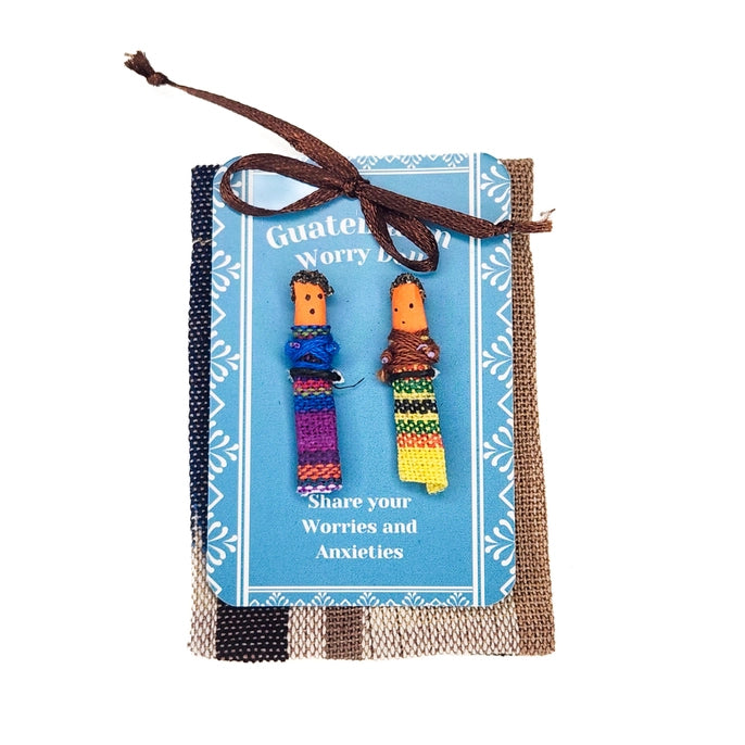 Worry dolls on a blue card with text, tied with brown string