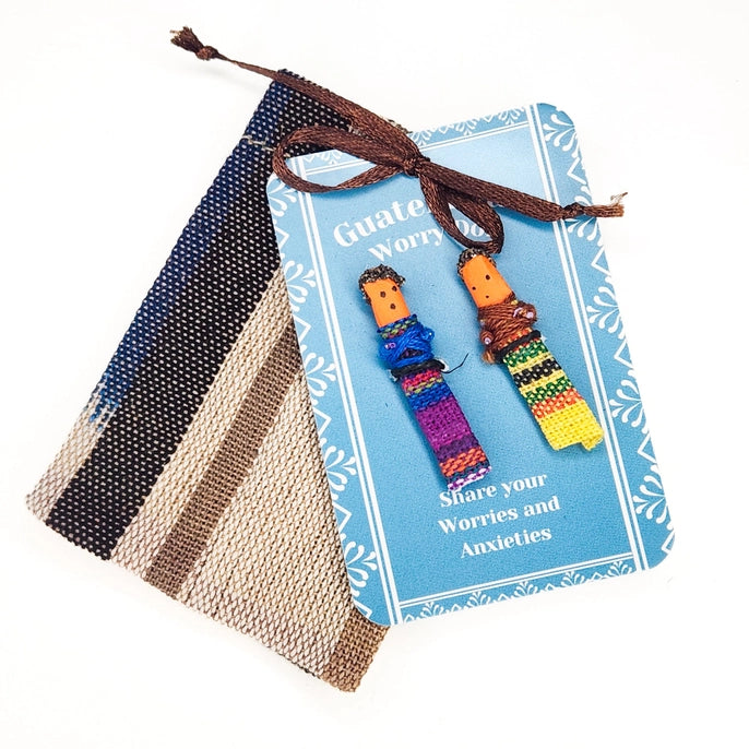 Worry dolls with a colorful string on a blue card labeled 'Guatemalan Worry dolls'.