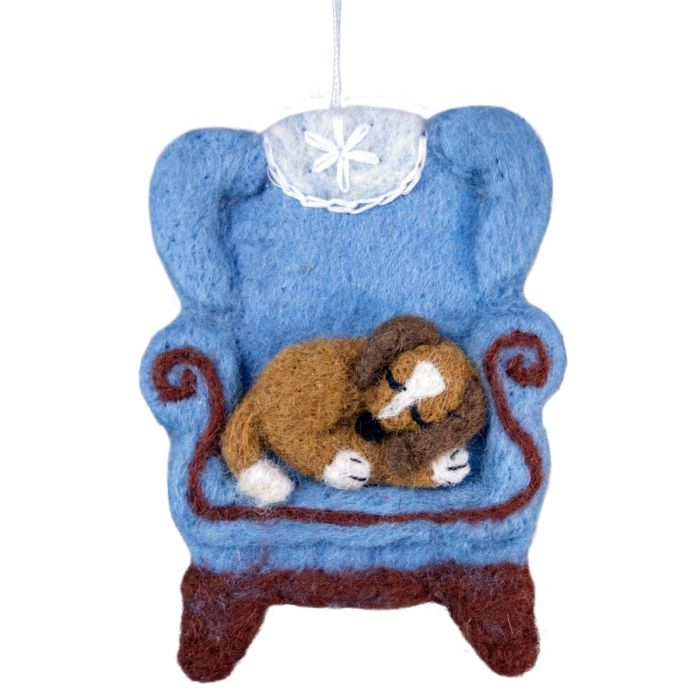 Decorative ornament of a dogs sleeping on a blue chair with a white background