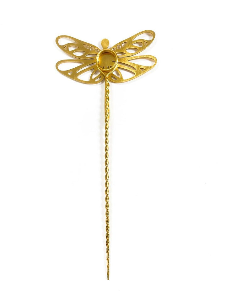 Gold dragonfly-shaped plant stake on a white background