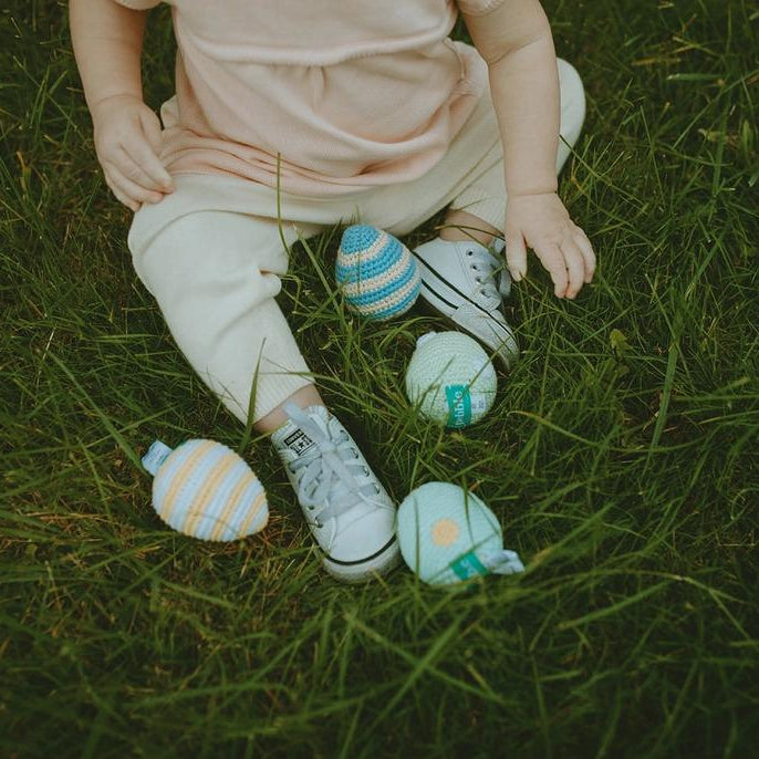 Easter egg baby toys getting played with in the grass
