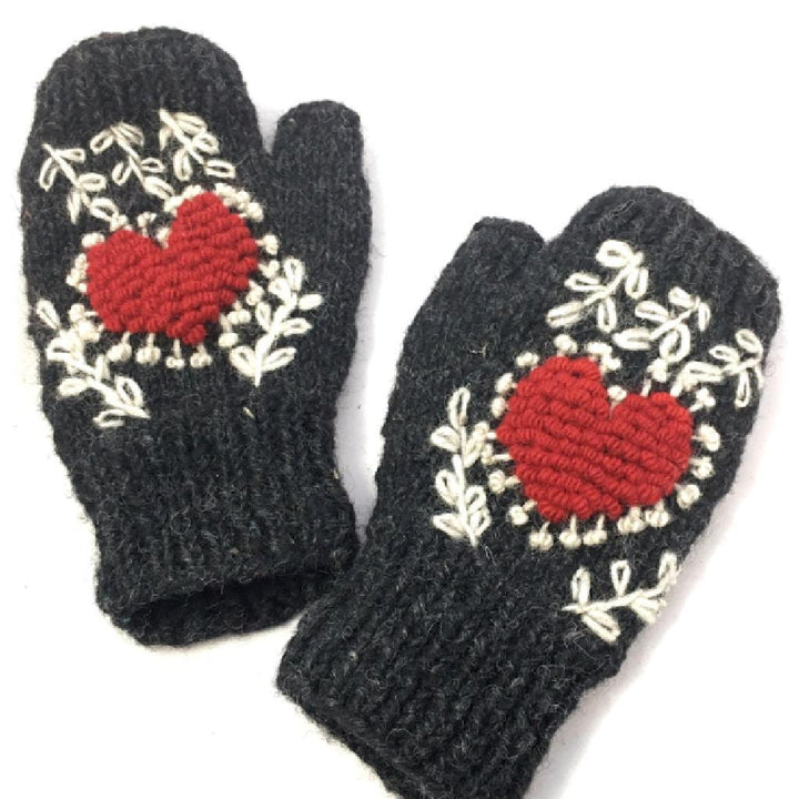 Pair of black mittens with red heart designs on a white background