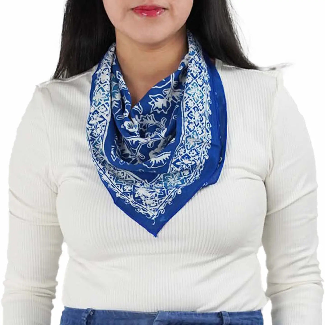 Person wearing a blue and white patterned scarf on a white background