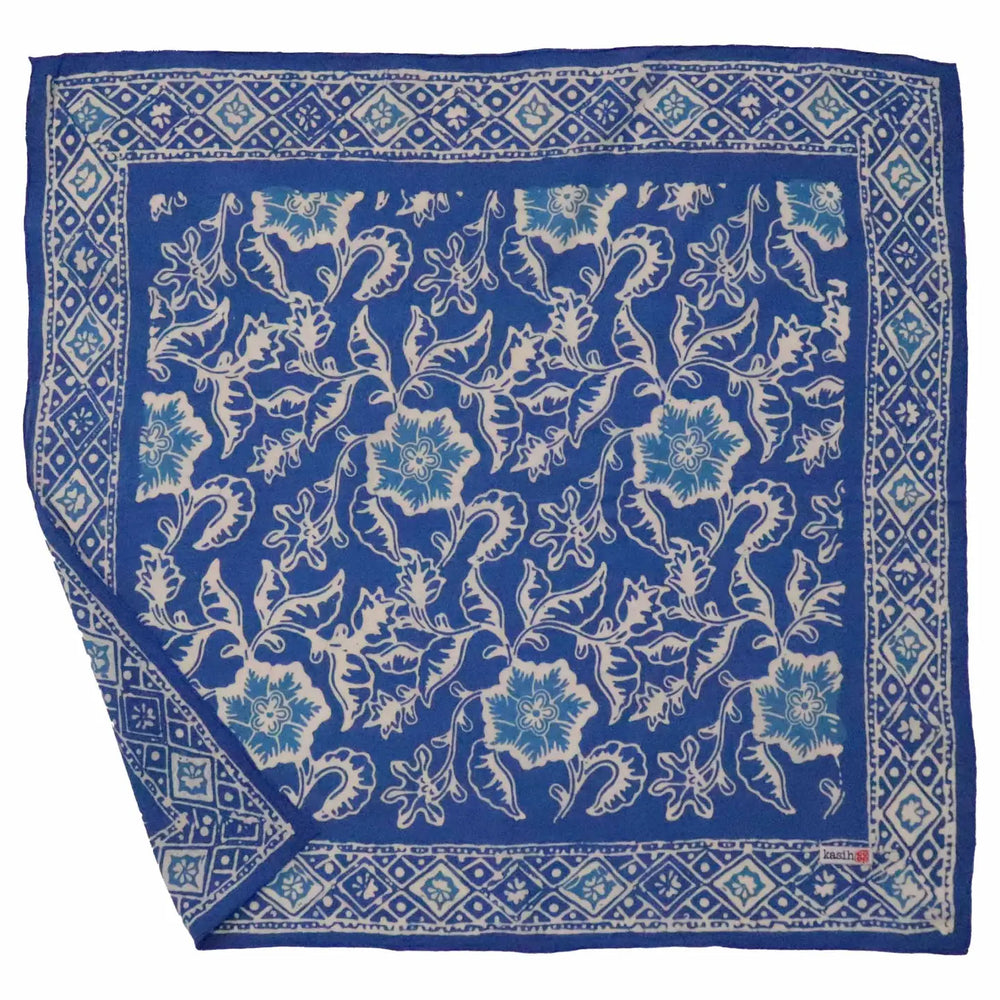 Blue floral patterned bandana with white border on a white background
