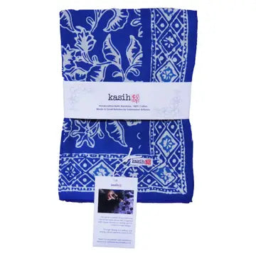 Blue patterned bandana with a white label on a white background
