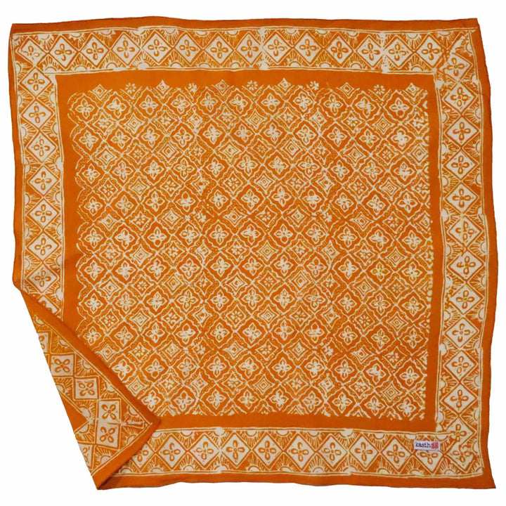 Orange bandana with white geometric pattern on a white background