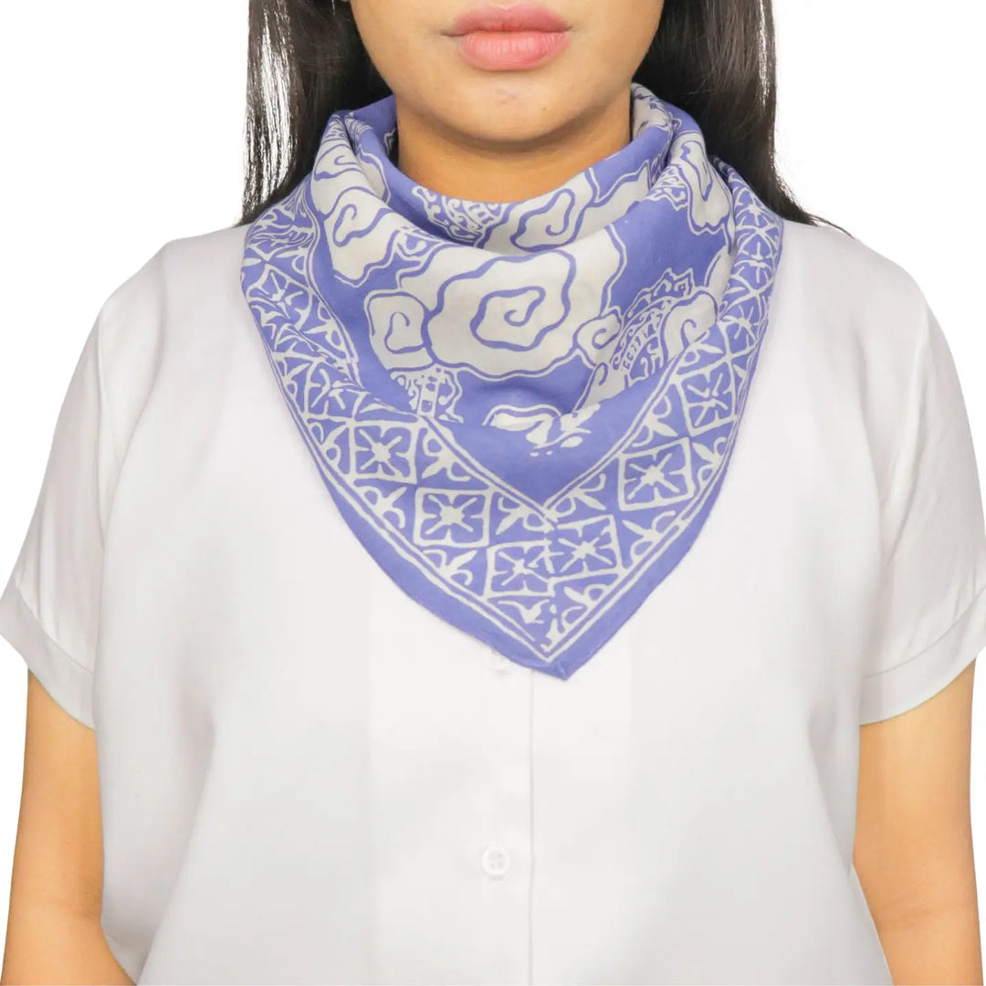 Person wearing a blue and white patterned bandana on a white background