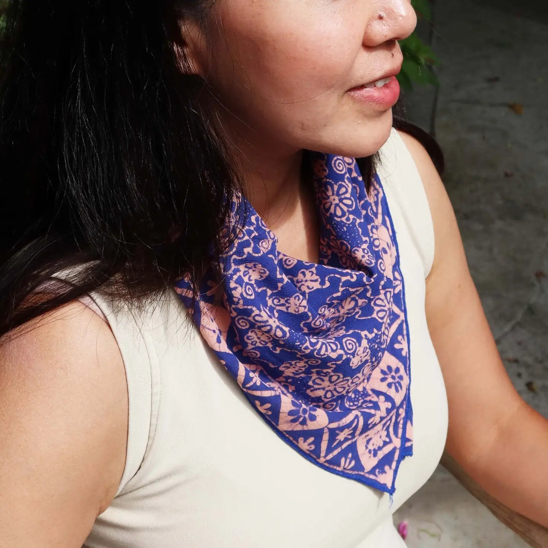 Woman wearing a blue patterned scarf on her neck