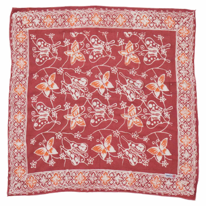 Red bandana with white and orange butterfly pattern on a white background