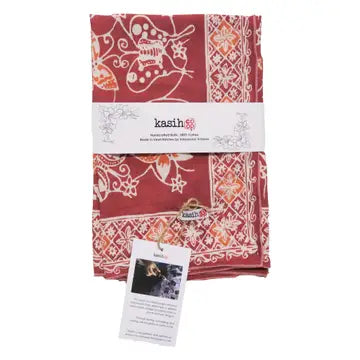 Red patterned fabric with 'kasih' branding on a white background