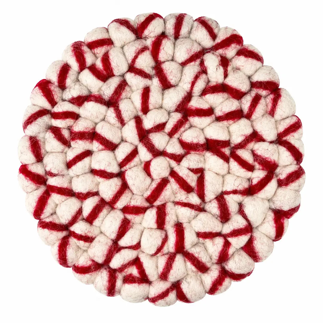 A round felted wool trivet with a red and off-white striped pattern, photographed from directly above on a solid white background.