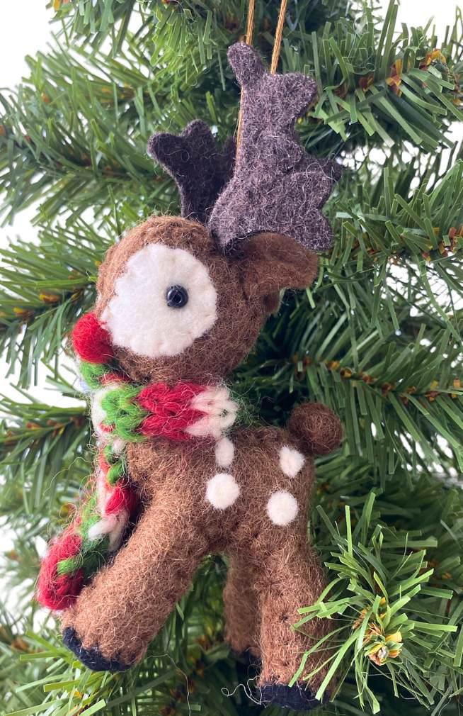 Felt reindeer ornament with a red nose wearing a scarf on a Christmas tree