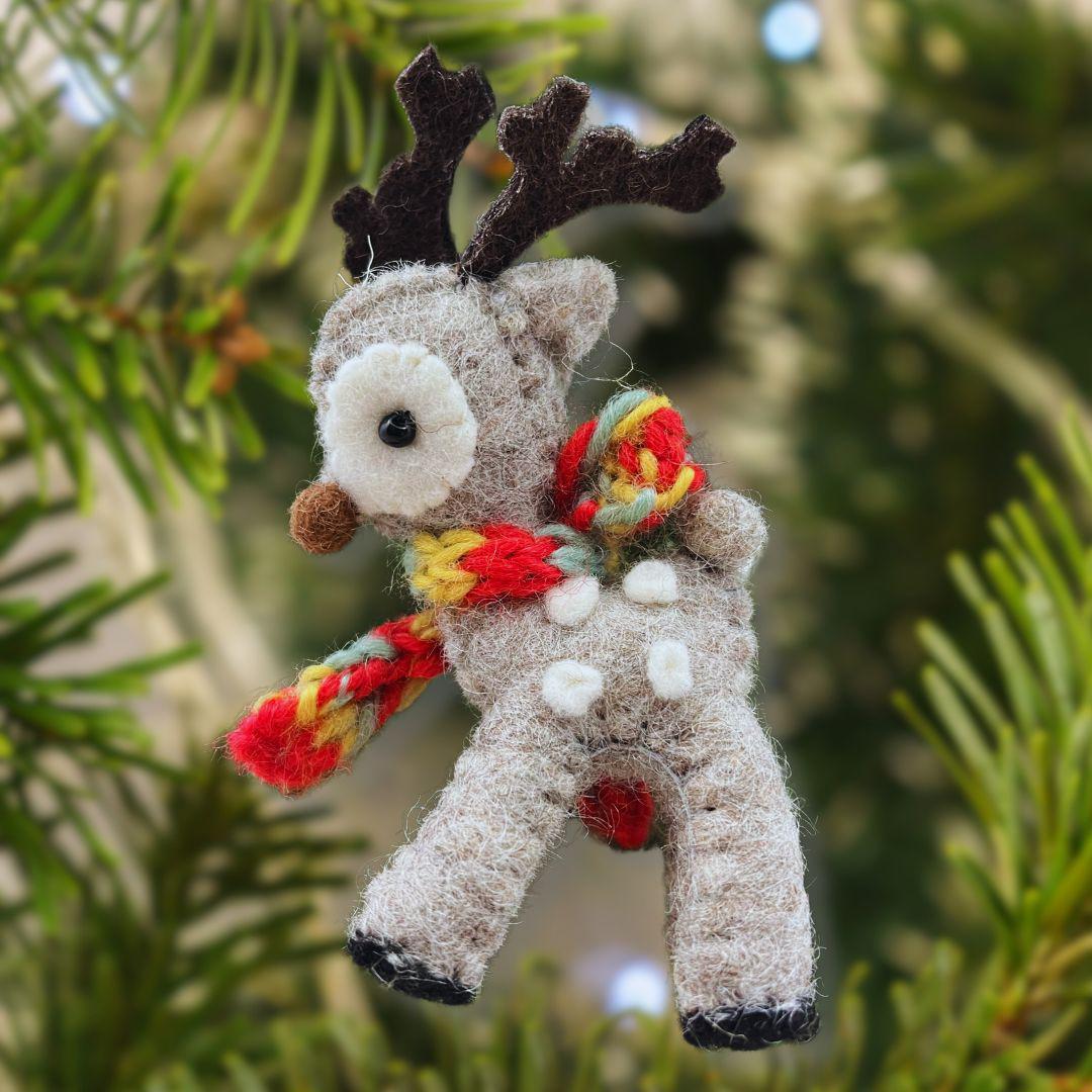 Small deer ornament with a colorful scarf on a Christmas tree