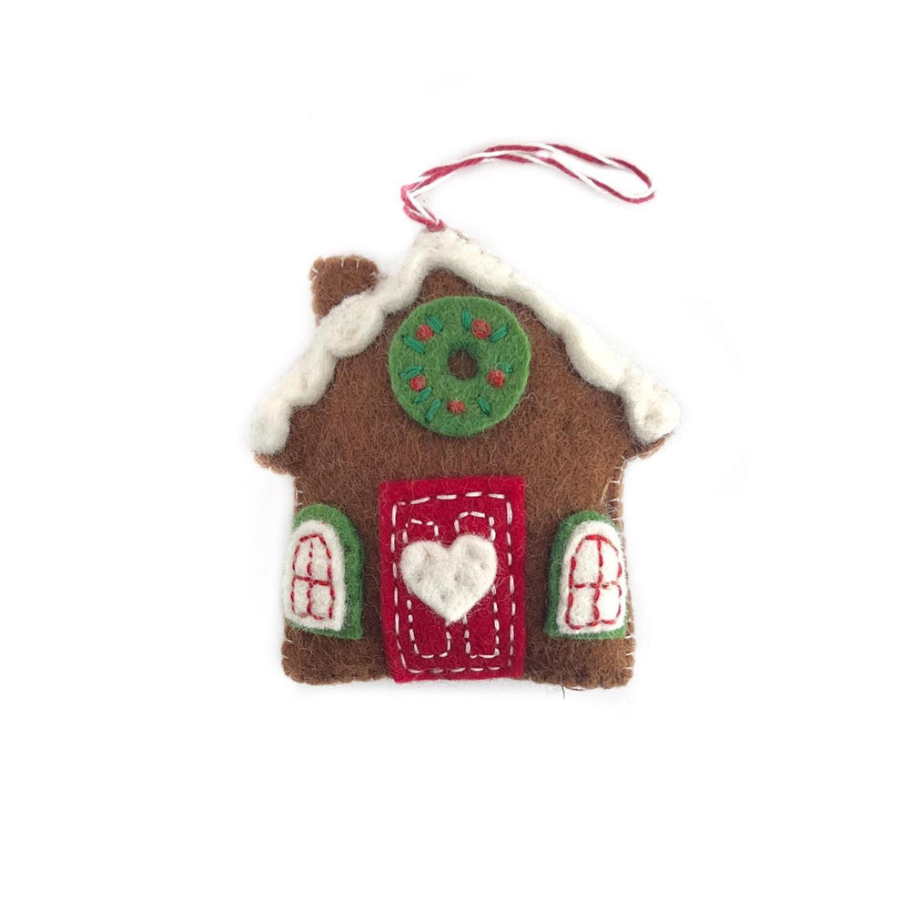 Felt gingerbread house ornament with a heart door on a white background