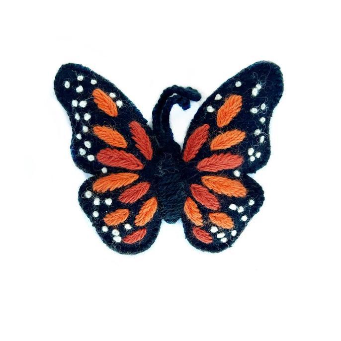 a felted monarch butterfly ornament on a white background. 