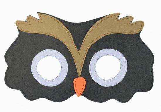 Owl mask with black face, brown feather-like design on top, white eyes, and orange beak on a white background