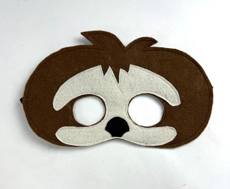 Brown and white sloth mask with a black nose on a white background