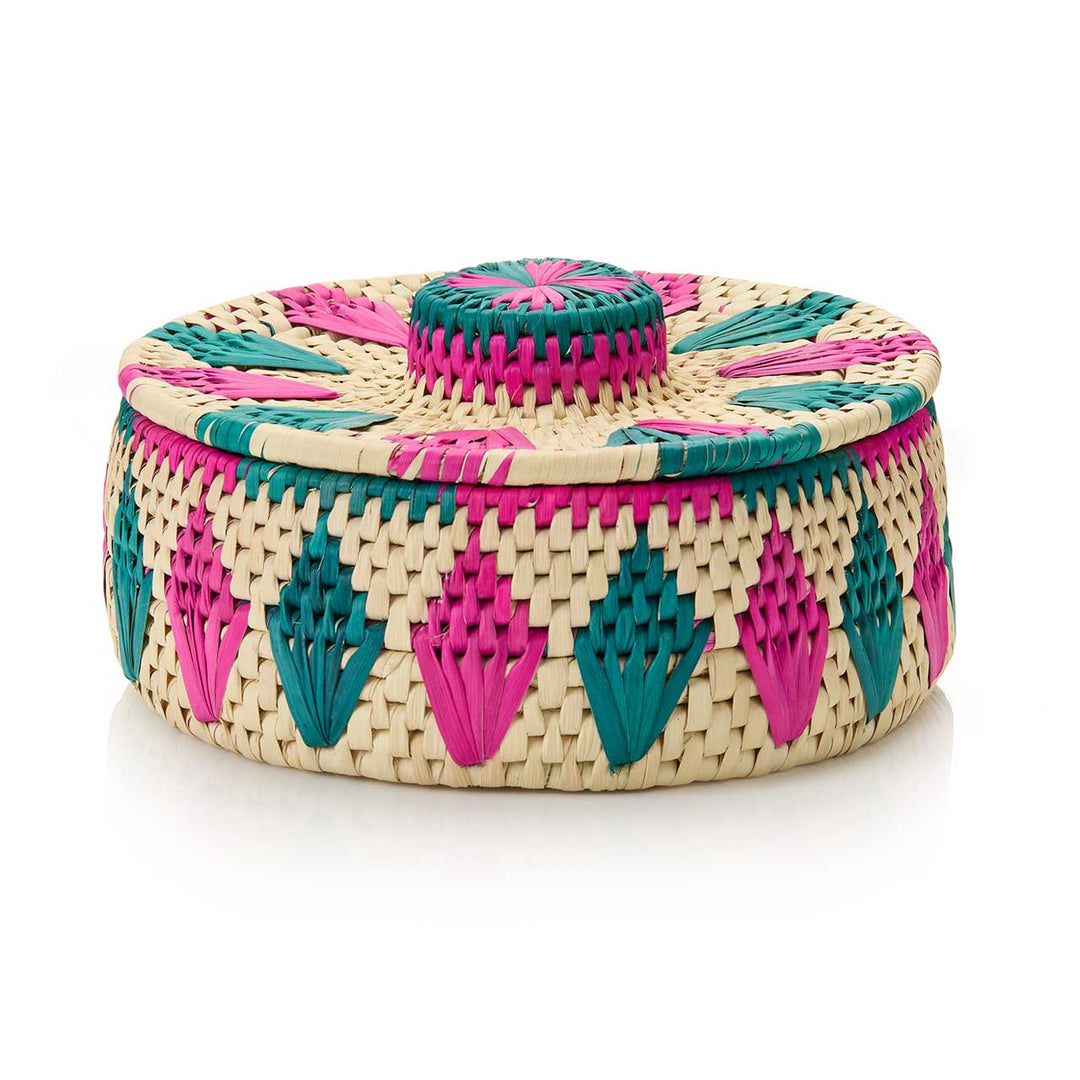 Woven basket with pink and green patterns on a white background