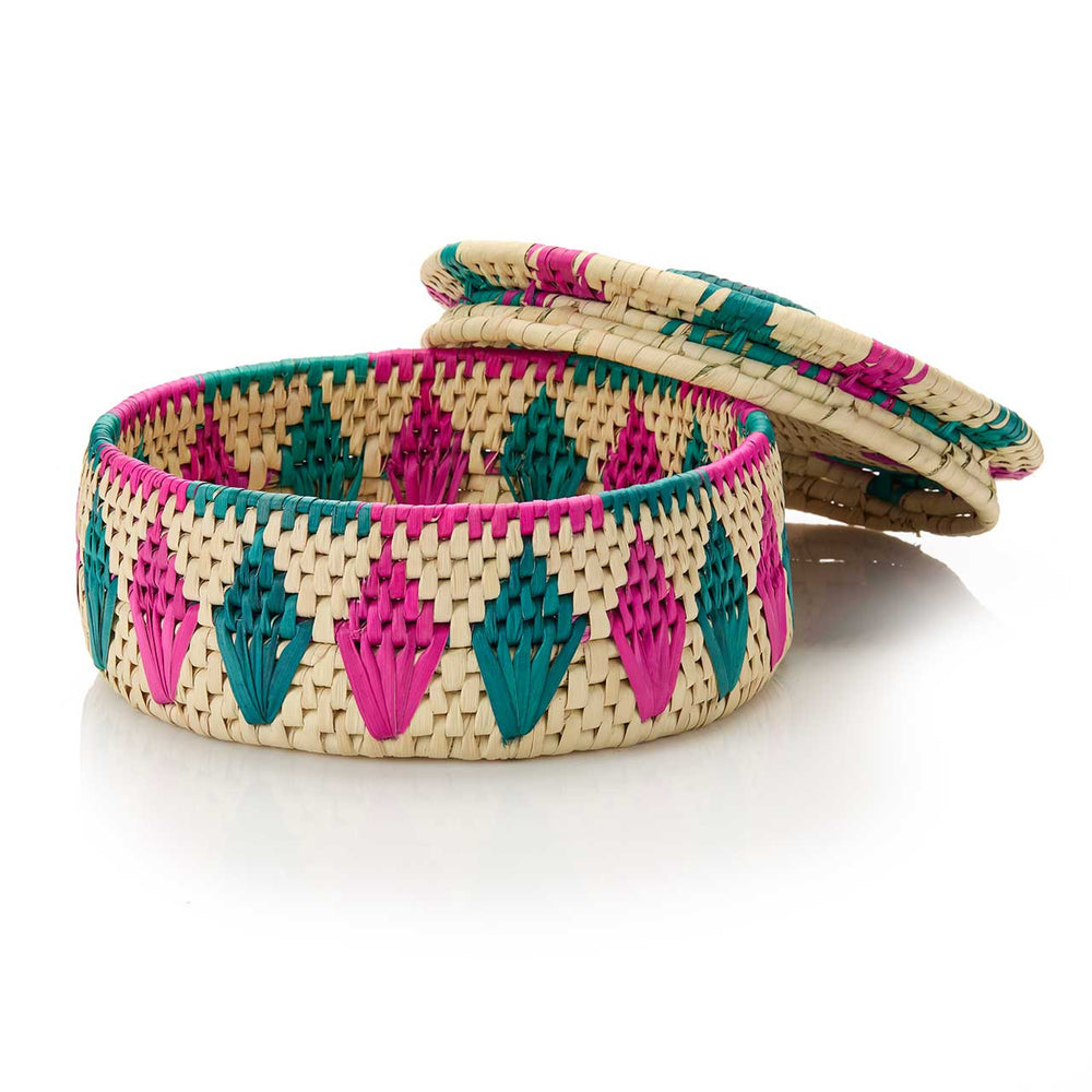 Woven basket with pink and green pattern on a white background