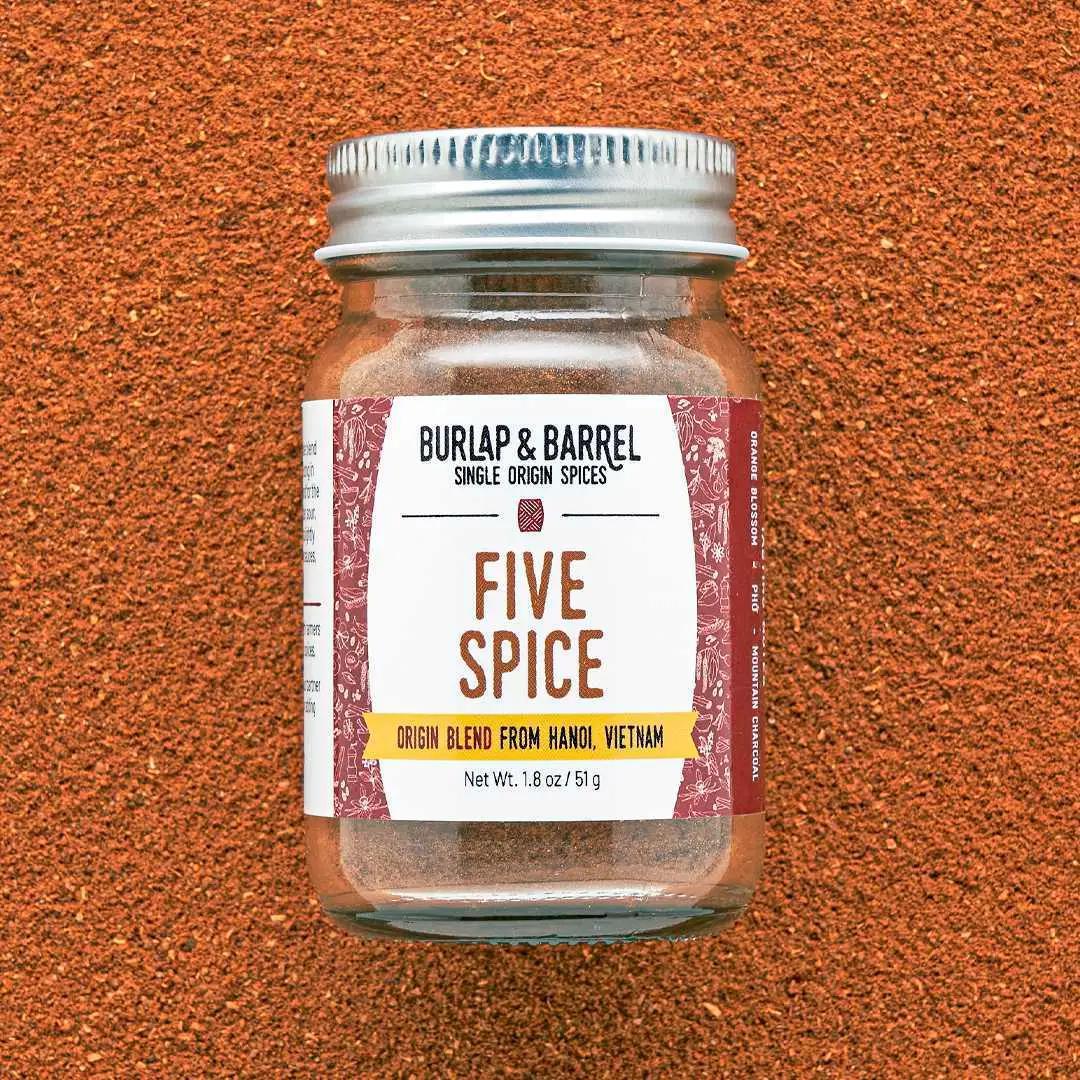 Jar of Burlap & Barrel Five Spice on a textured brown background