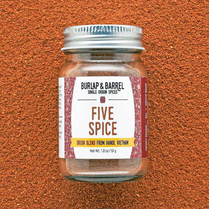 Jar of Burlap & Barrel Five Spice on a textured brown background