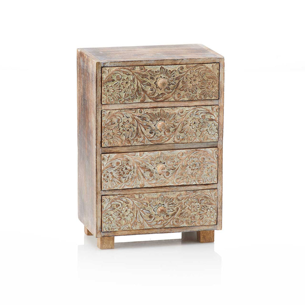 Wooden chest of drawers with intricate carvings on a white background