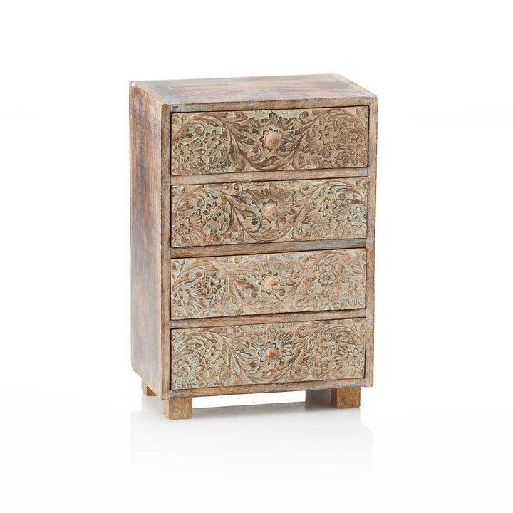 Wooden chest of drawers with intricate carvings on a white background