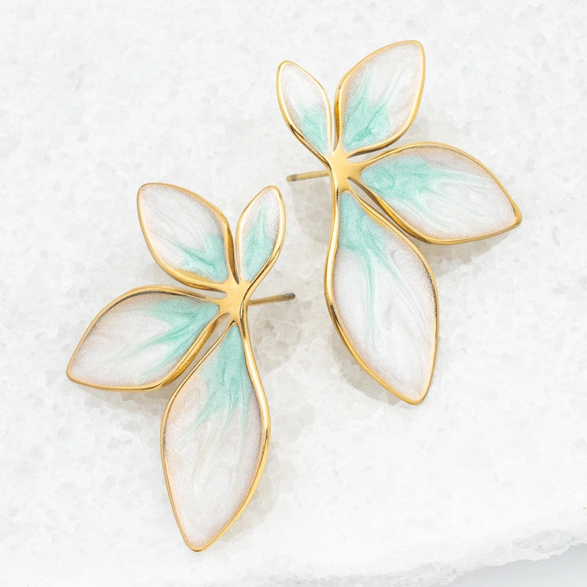 Pair of earrings with gold frames and light green leaf-shaped stones on a white background