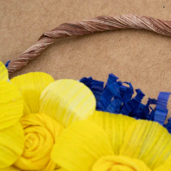 Decorative basket with yellow and blue flowers on a brown background