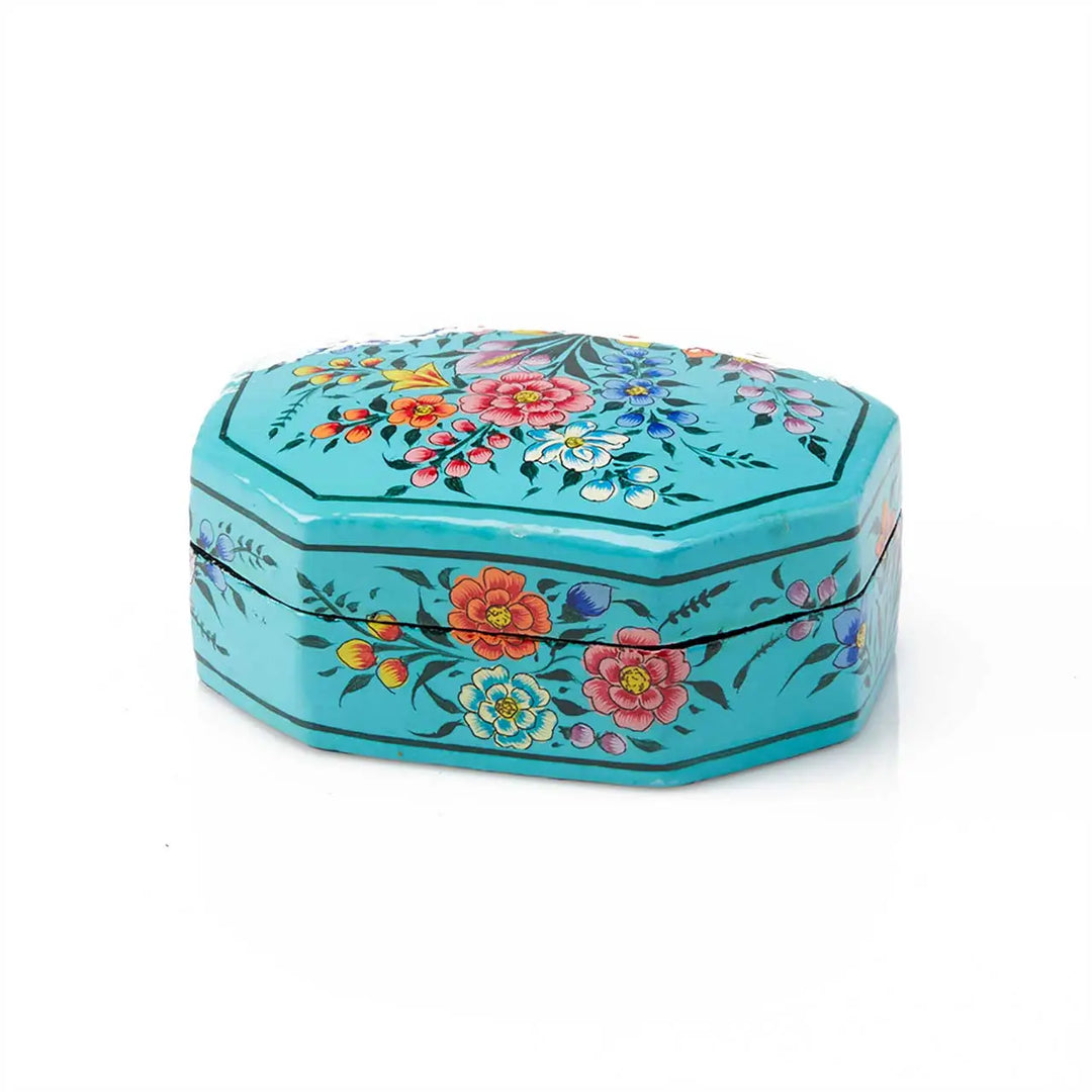 Decorative hexagonal box with floral patterns on a white background