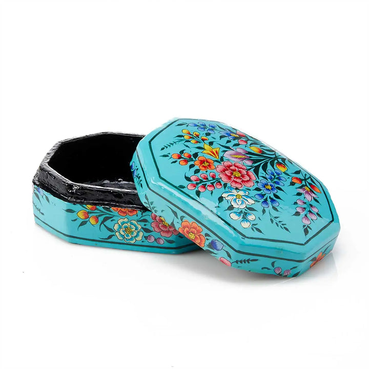 Decorative turquoise box with floral patterns on a white background