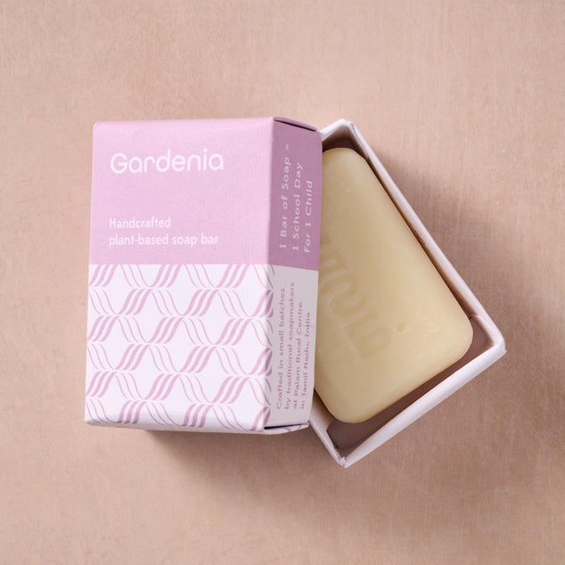 Handcrafted plant-based soap bar with packaging on a beige background