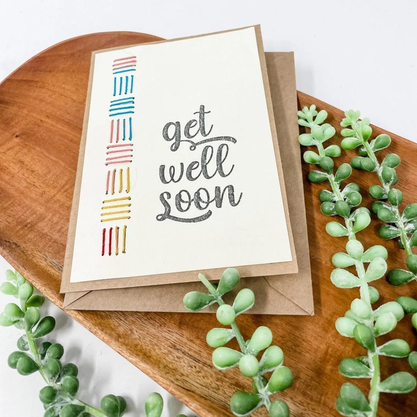 Get well soon card with decorative elements on a wooden tray