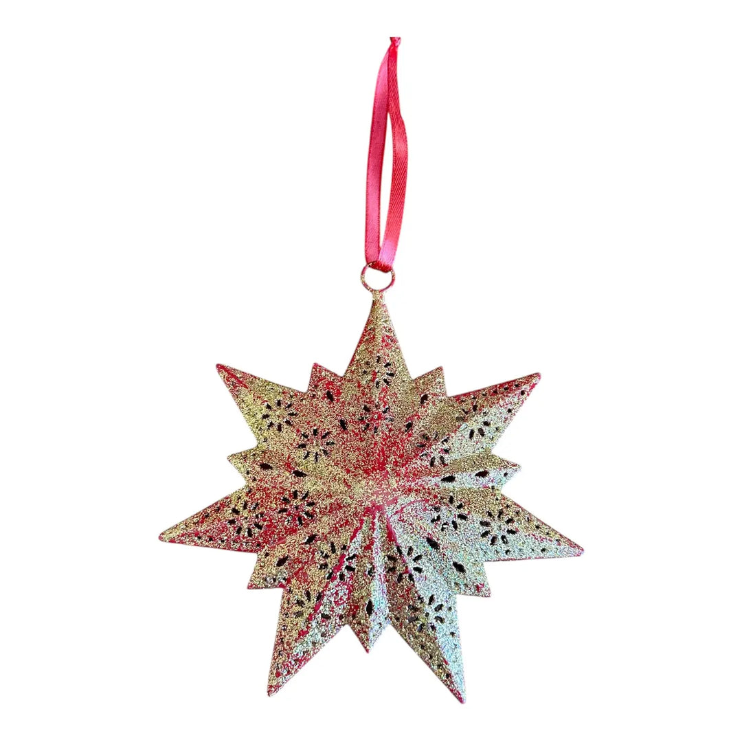 A glittery star-shaped Christmas ornament with a red ribbon hanger, featuring a gold iridescent finish, set against a plain white background.