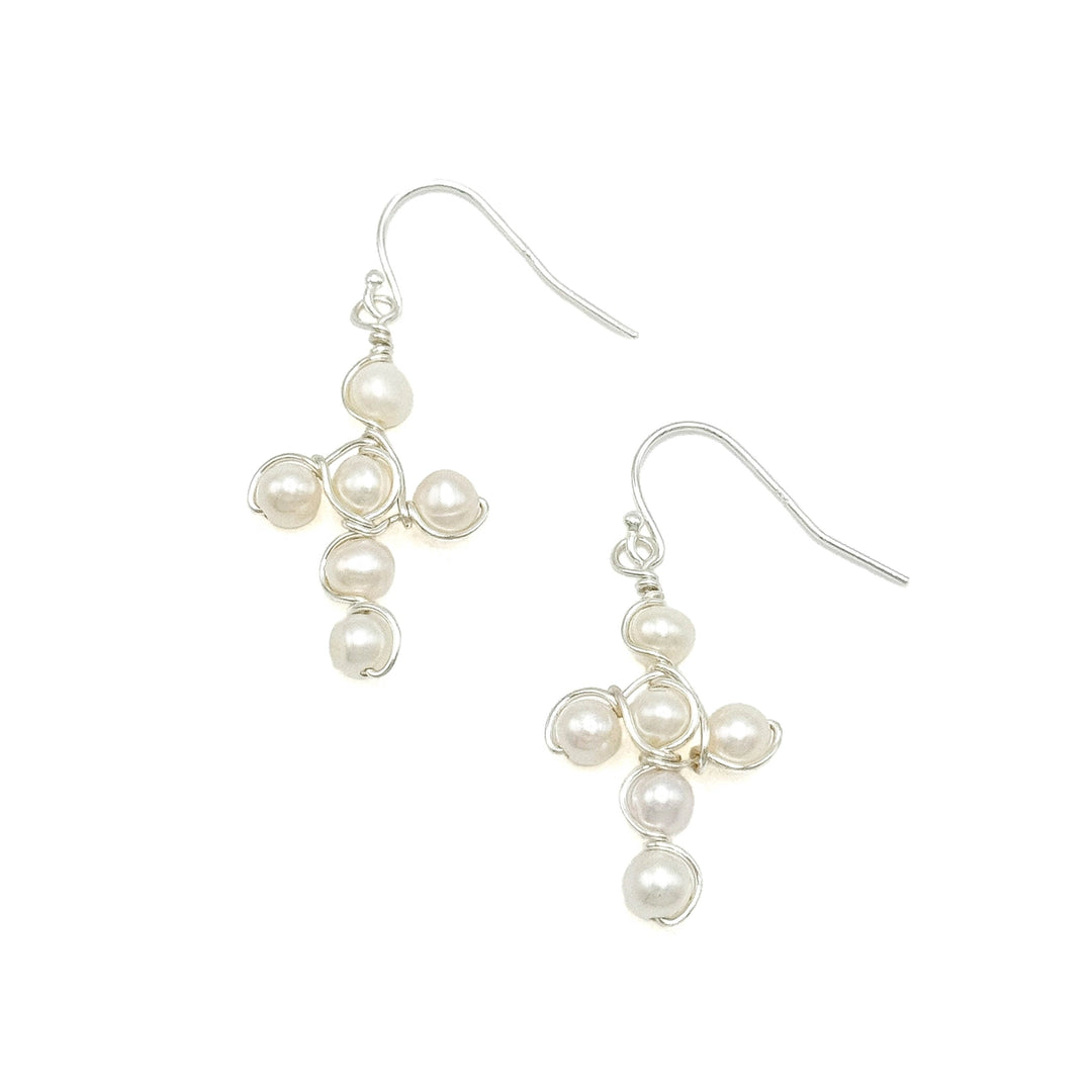 Pearl cross earrings with silver metal on a white background