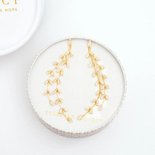 Gold leaf earrings on a white box with 'Starfish Project' branding.