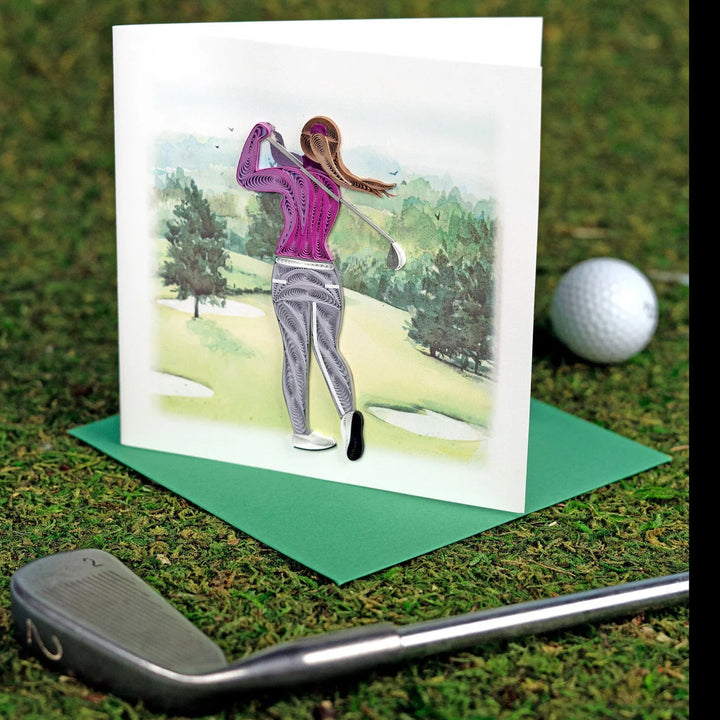 Greeting card with a golfer illustration on grass with a golf club and ball.