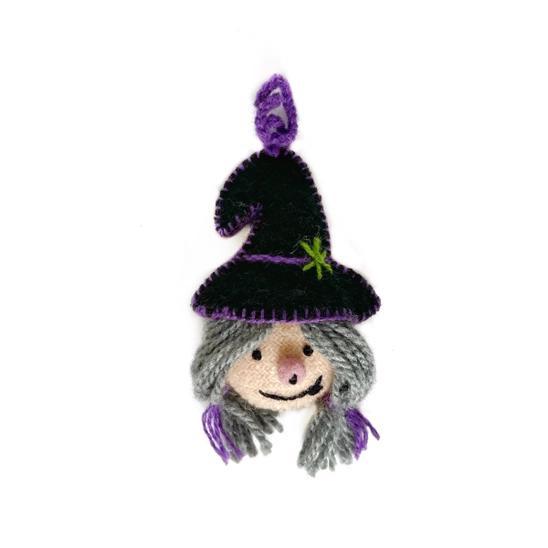 Handmade Halloween ornament of a witch wearing a black witch hat.